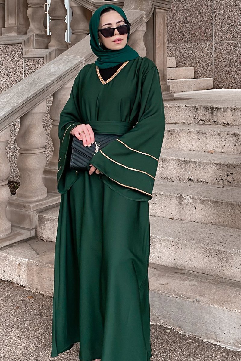 abaya dress green EMERALD ABAYA Emerald green embellished Abaya set with flounced sleeves. Comes with a dress and headscarf. Abayas from Almahra Atelier at Boksha